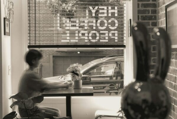 a man sitting at a table in front of a window